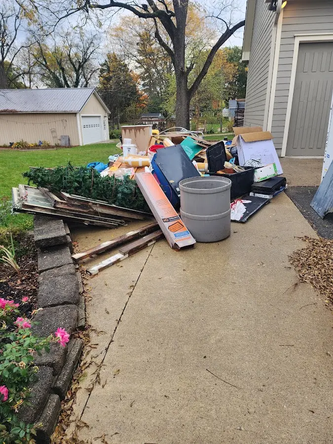 Dumpster being loaded with debris for Commercial Dumpster Rental in Purcell